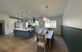 a kitchen and dining room with a table and chairs, painted in grey white - premium paint